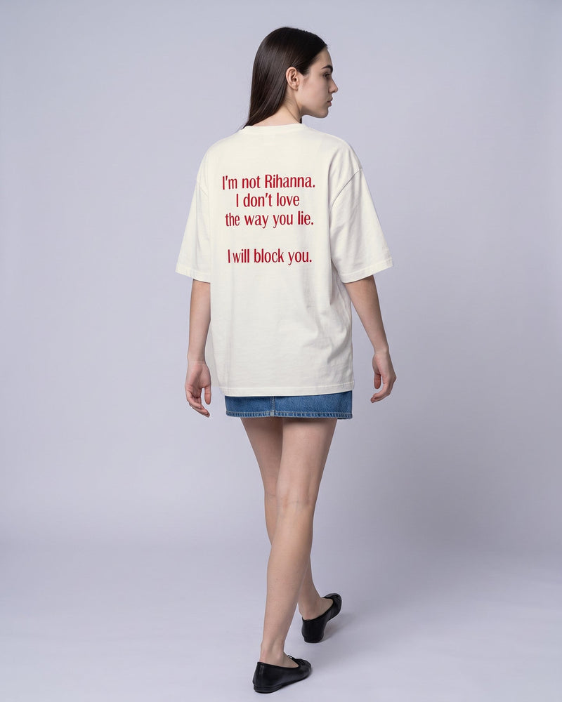 Camiseta oversized feminina MALTA® i will block you off-white vista de costas no estúdio, com a frase “i'm not rihanna, i don't love the way you lie, i will block you”